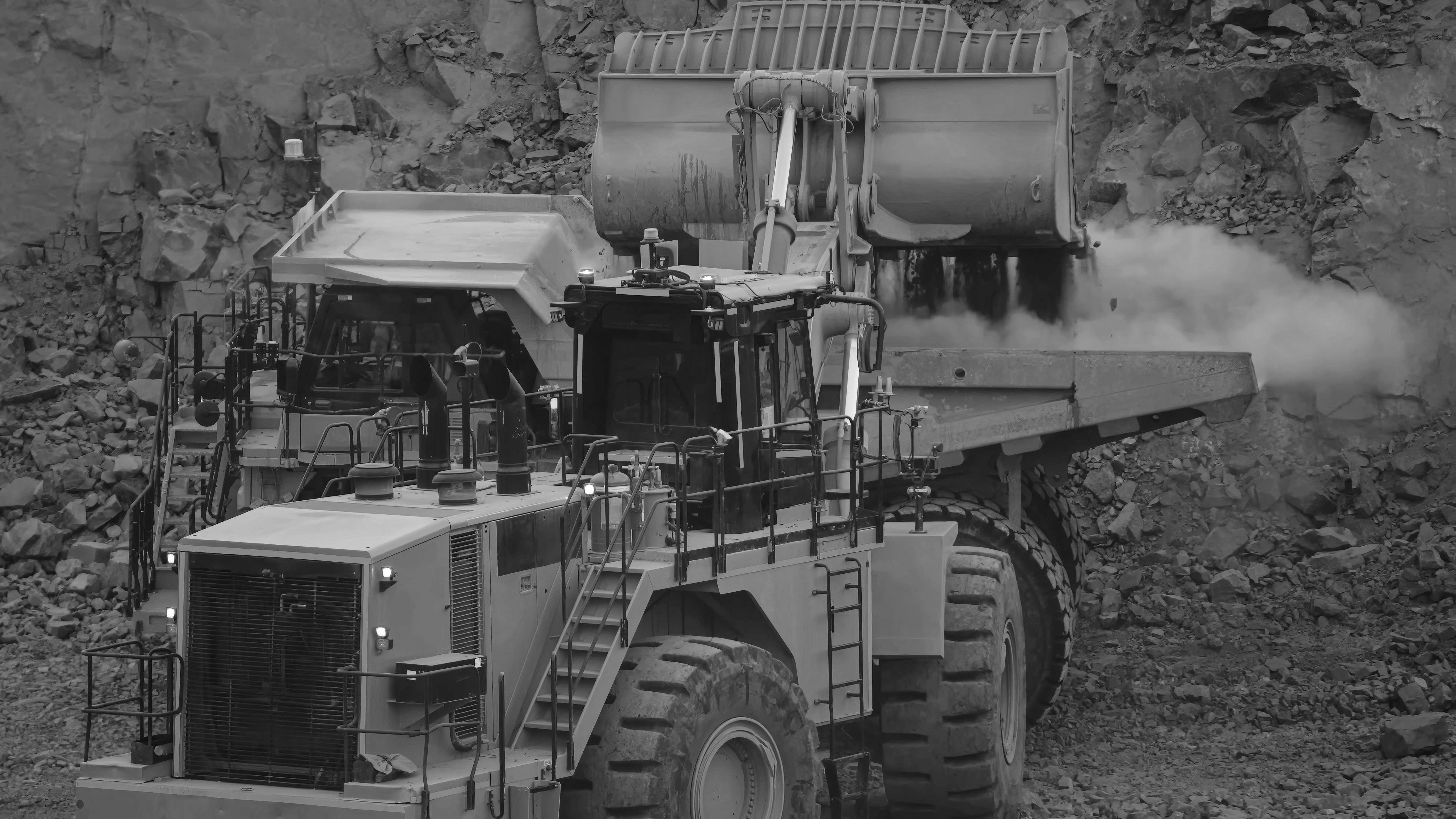 Heavy construction equipment wheel loader and dump truck at work site