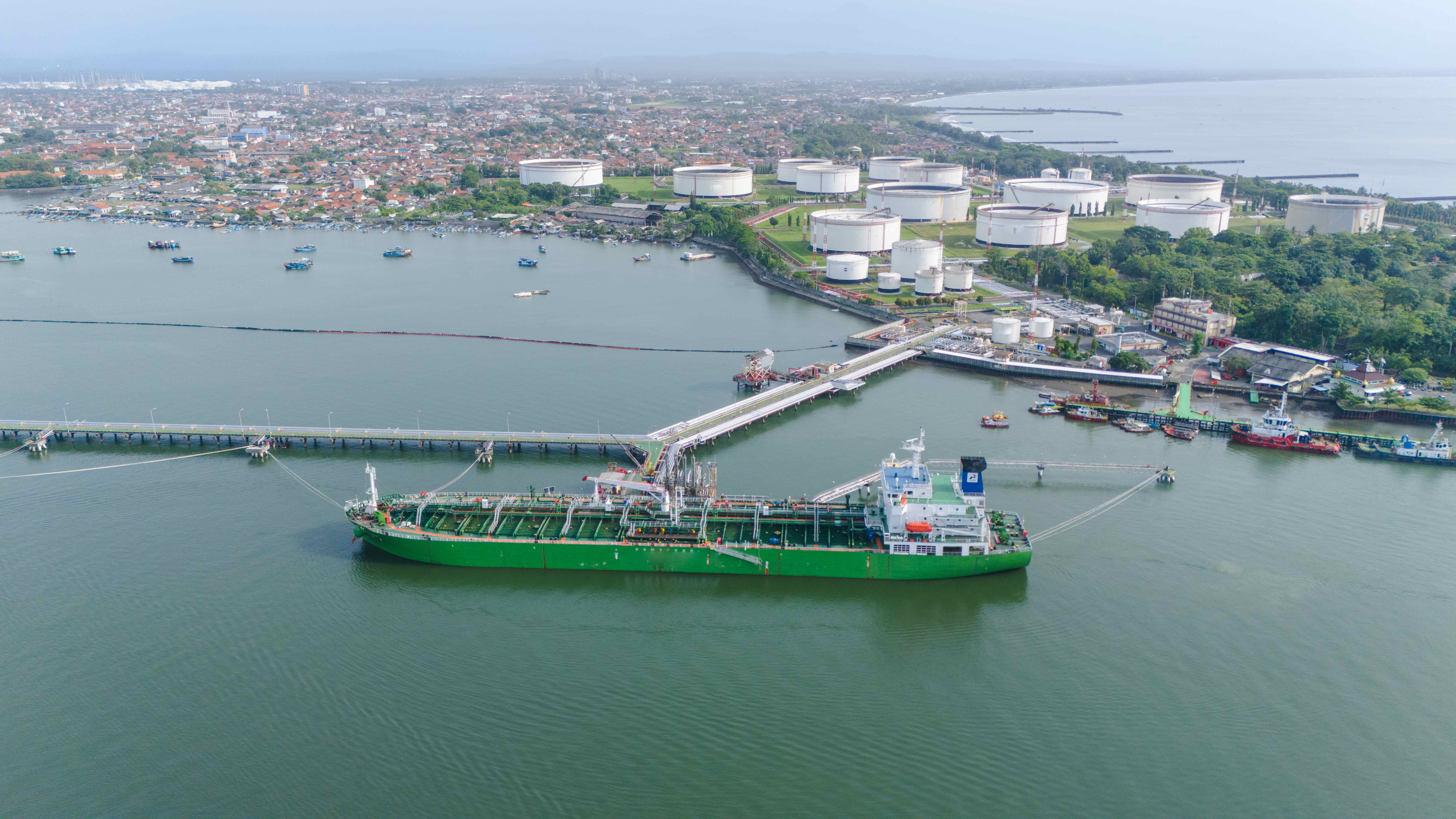 Oil tanker at port with storage tanks - depicting global supply chain