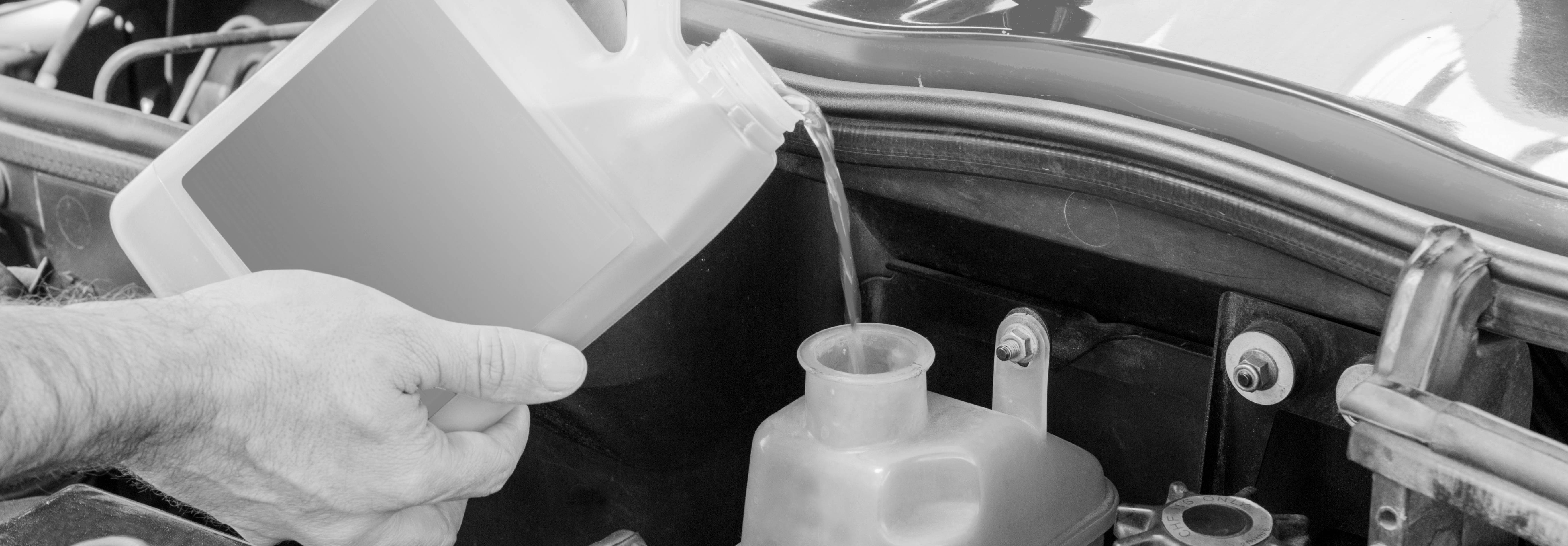 Pouring coolant into vehicle reservoir