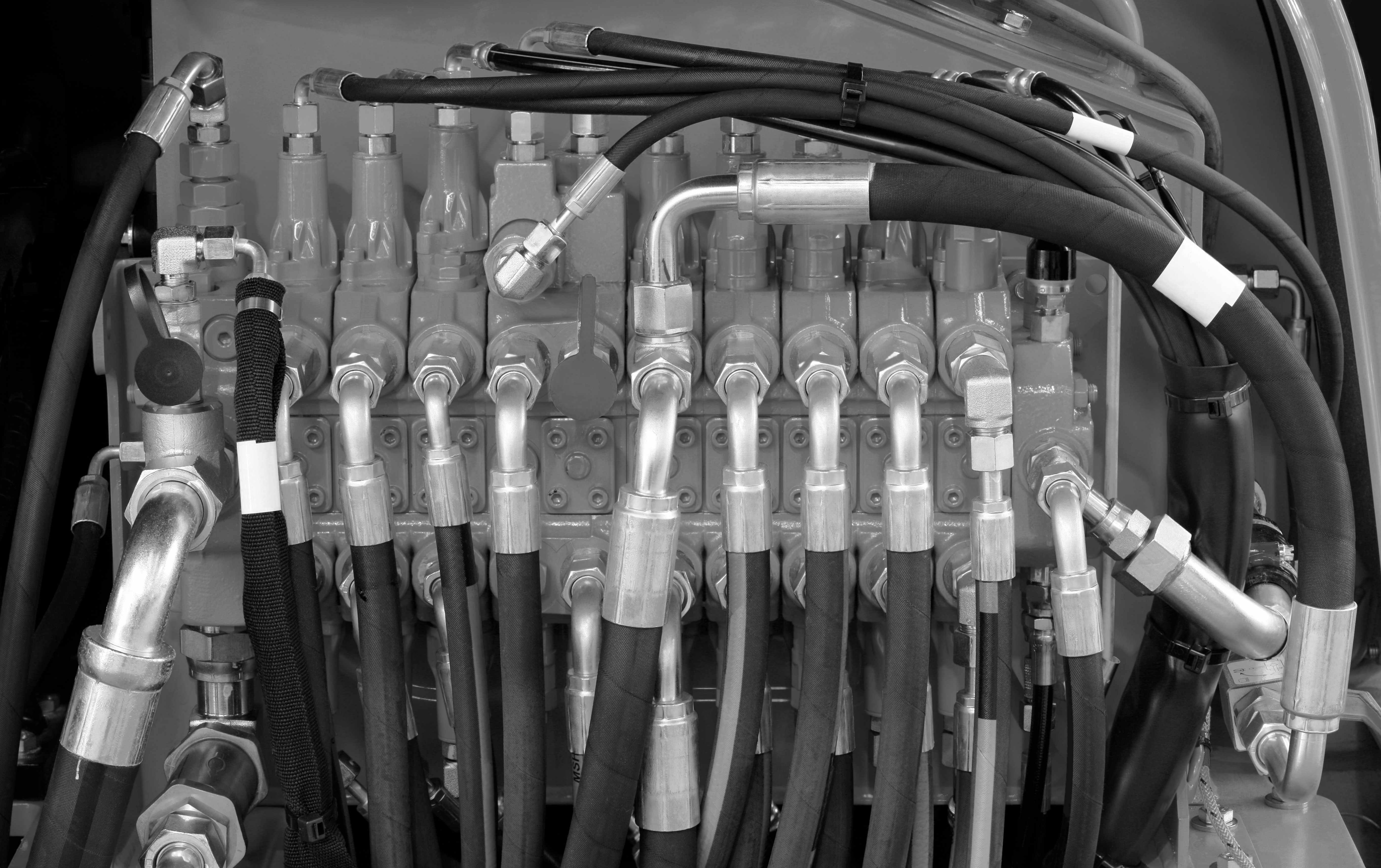 Hydraulic system manifold with hoses and fittings